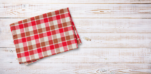 Folded napkin, towel or linen tablecloth on wooden desk top view.