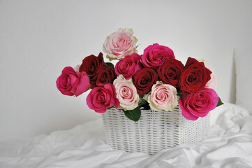 bouquet of beautiful pink and red roses in a basket