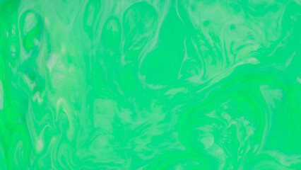 Fluid art green background. Abstract liquid backdrop. Green turquoise stains on liquid surface
