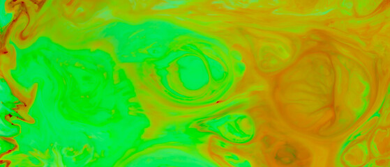 Fluid Art background. Abstract ink painting green-orange background. Surface of liquid with blurry paint spots. Trendy backdrop