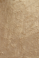 Abstract texture with relief and sharply defined shadows on a beige background