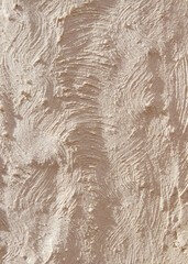 Relief texture with irregularities and clear shadows prints and lines on a beige background