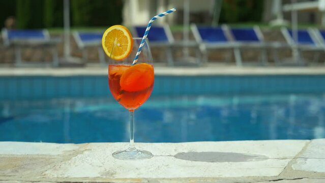 Cold and refreshing aperol spritz cocktail is the perfect summer drink at poolside. Holiday vacation.