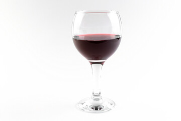 A wide glass transparent glass with red wine, half full, on a white background, isolated glassware with a drink