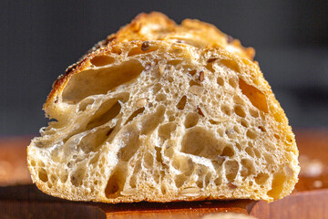 Bread macro. Bread pores. Fresh baguette with grains macro.Bakery advertisement. Seeds in bread....