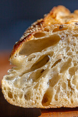 Bread macro. Bread pores. Fresh baguette with grains macro.Bakery advertisement. Seeds in bread. Freshly baked bread. French baguette cut. Fresh bakery. Bun in a cut. Baking from the oven. Bakery