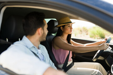 Smiling man and woman enjoying driving