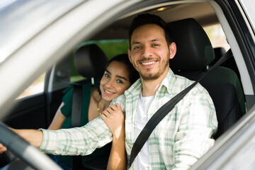 Attractive smiling couple in the car