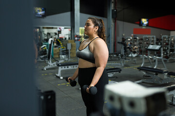 Fototapeta na wymiar Plus size woman doing a new workout routine