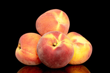 Fototapeta na wymiar Four sweet organic peaches, close-up, isolated on black background.