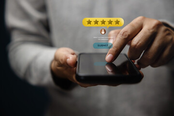 Customer Experiences Concept. Happy Client Using Smartphone to Submit Five Star Review Rating for Online Satisfaction Surveys. Positive Feedback on Mobile Phone