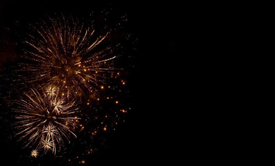 Fototapeta premium Golden fireworks in the black night sky
