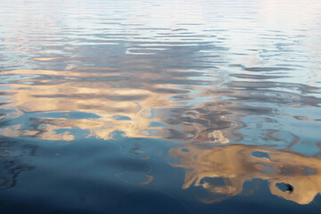 clouds are reflected in the water of the river