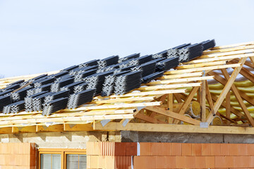 Top view, wooden roof structure of frame beams of the farm house, metal tiles.