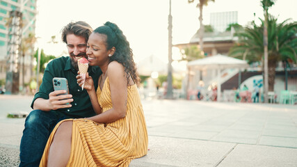 portrait of happy man and smiling woman watching video on smartphone. Close-up of joyful young...