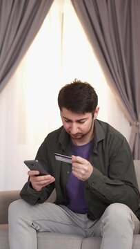 Banking problem. Declined payment. Financial security. Angry man phone shopping online with credit card annoyed with account protection service failure at home vertical.