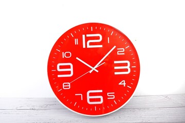photo of a red clock on a white background