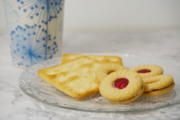 Photo of breakfast cookies, bread and coffee mugs.