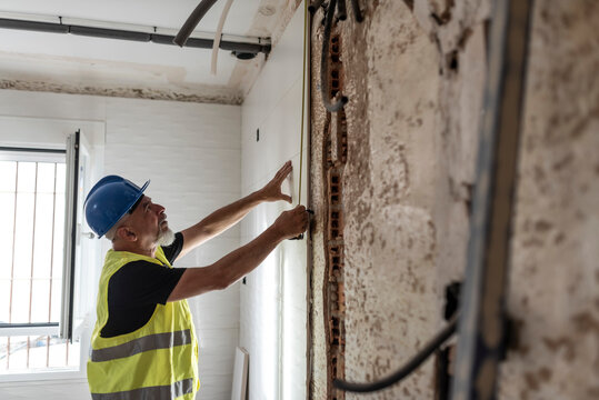 Construction worker prepares the kitchen tiles in a home renovation