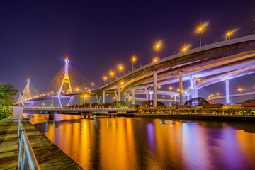 Fototapeta na wymiar Light up on the highway bridge across the river