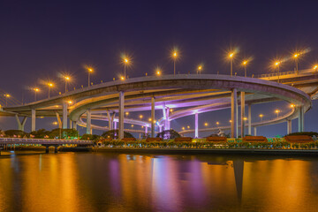 Fototapeta na wymiar Light up on the highway bridge across the river