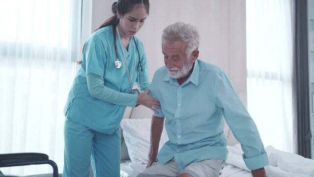 elderly patient in health insurance concept, old senior man using wheelchair by nurse care support, professional doctor working for medical assistance with male adult retirement person at hospital