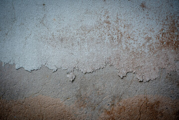 The old wall has discolored and cracked paint.