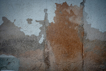 The old wall has discolored and cracked paint.