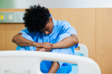 Obraz premium Unhappy lonely depressed and sad feeling. Black man patient lay down on hospital bed at medical center.