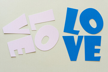 love spelled out in cut paper letters in pink and blue