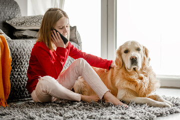 Preteen girl with golden retriever dog