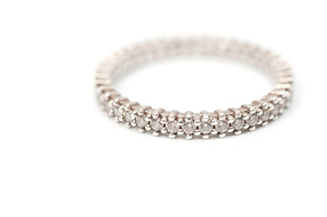 Silver color ring with decorative stones on a white background.