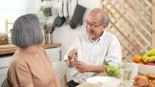 senior adult retirement patient in food feeding concept, elderly pensioner man eating by support of old woman at  home, mature couple family person having health care and happy together in a house