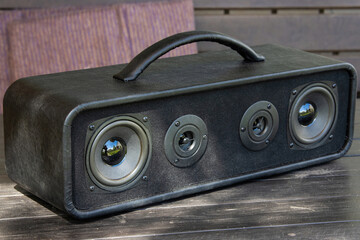 Powerful handmade bluetooth speaker in the backyard of a country house