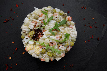 Salad Olivier on a black background, Horizontal