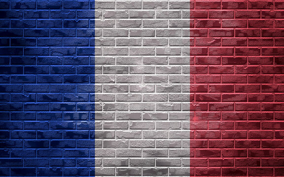 National flag of the country on a brick wall, background and texture.Flag France. 