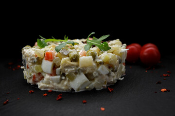 Salad Olivier on a black background, Horizontal