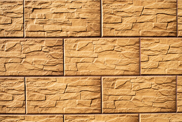 Yellow stone wall texture with bricks