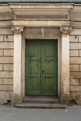 Green entrance door in old stone abandoned castle. Poland, Warsaw.