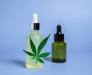 hemp cosmetic oil or serum, treatment for hair and scalp. Medical marijuana CBD oil and green leaf