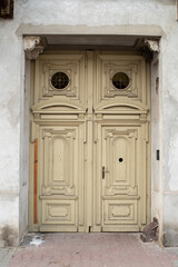 Modern baroque style wooden door in old stone white house. Poland, Warsaw.