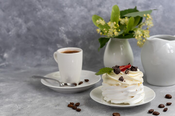 Pavlova meringue cakes with whipped cream and fresh strawberries, mint leaves. Selective focus.