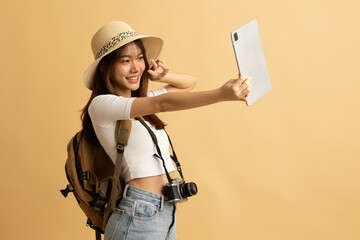 Young Asian girl dress in white shirt and jeans ready to travel on vacation on yellow isolated...
