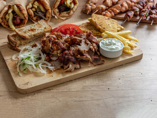 Gyro Greek sliced meat, ethnic dish, pita bread, tzatziki yogurt on wooden table, close up view