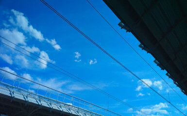 Railway power lines on blue sky backdrop