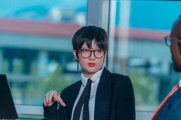 Female manager leads brainstorming meeting. Businesswoman in meeting with colleagues in conference room.