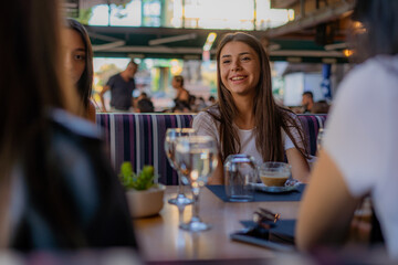 Smiling and enjoying their time at the cafe while talking