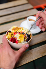 Mini waffle bowl with fruit and milk.
