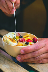 Mini waffle bowl with fruit and milk.