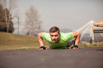 Male sportsman is getting ready for the push ups